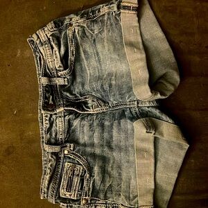 Distressed blue jeans, shorts pockets, size 26